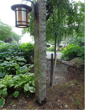The reclaimed granite lamp post lends a venerable look to the landscape.